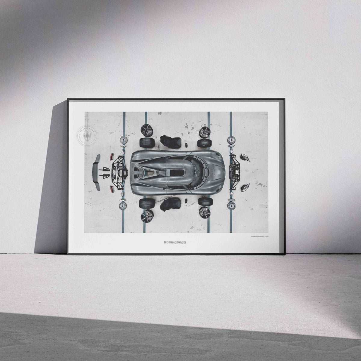 A framed art print featuring a top-down technical schematic of an Agera S hypercar, leaning against a minimalist white wall on a gray floor.