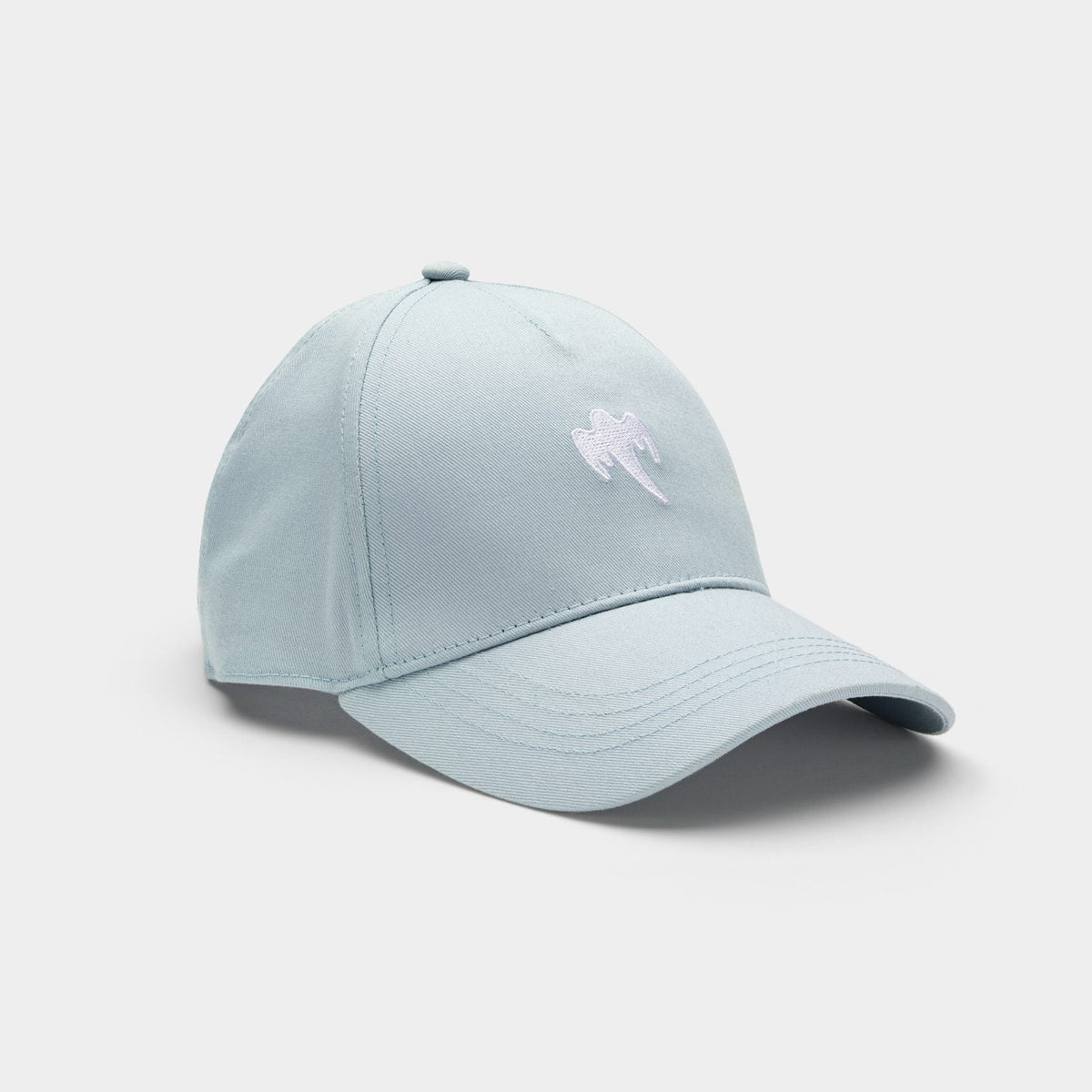 A light blue cap with a small white embroidered ghost logo on the front, photographed on a clean, light gray background.