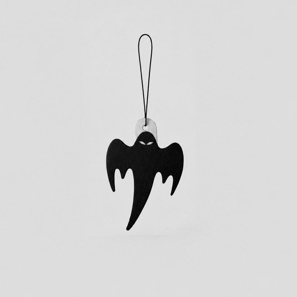 A black ghost-shaped hanging air freshener with a thin black loop at the top, shown against a plain light gray background.