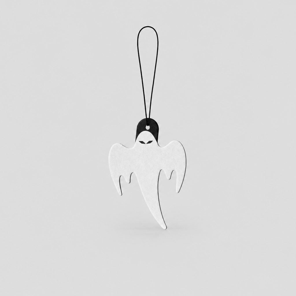 A white ghost-shaped car air freshenerwith a black loop at the top, shown against a solid light gray background.