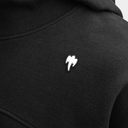 Close-up of a Koenigsegg black hooded sweatshirt featuring a small white embroidered ghost logo on the chest.