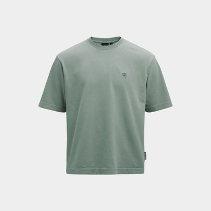 A sage green short-sleeve crewneck t-shirt with a small dark green embroidered logo on the left chest, displayed on a light gray background.