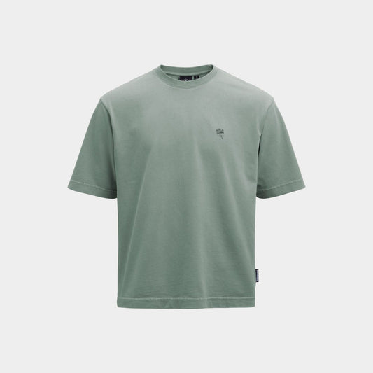 A sage green short-sleeve crewneck t-shirt with a small dark green embroidered logo on the left chest, displayed on a light gray background.