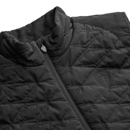 Close-up of a black quilted Koenigsegg jacket with diamond stitching, a high collar, and a small shield logo on the chest.