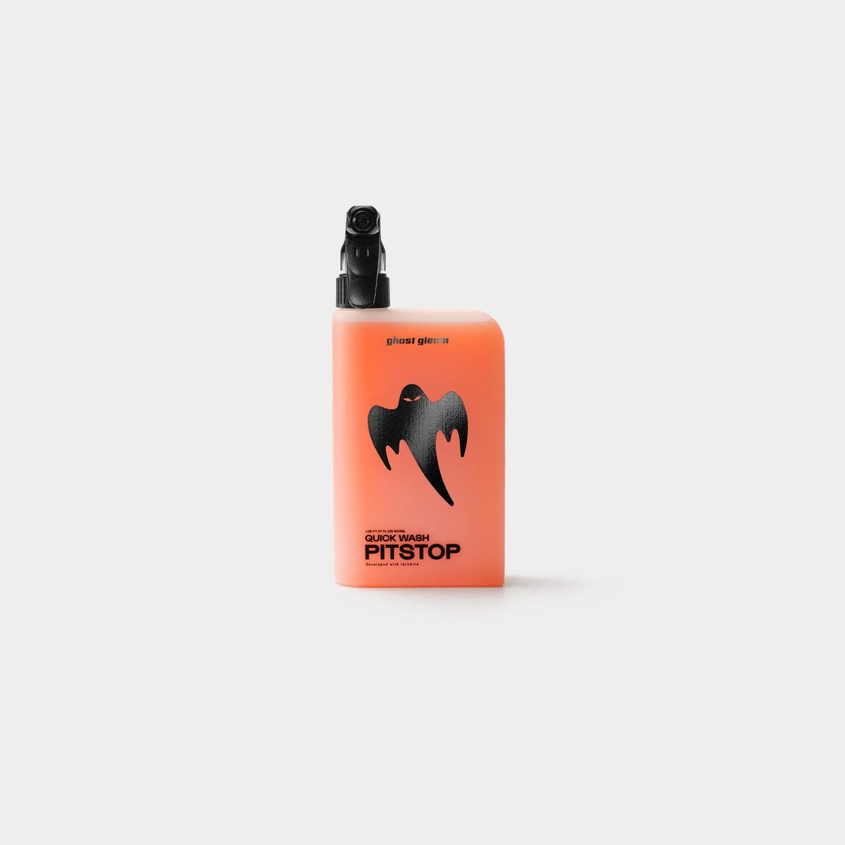 A small rectangular spray bottle with a black nozzle, featuring a peach-orange body and a black ghost logo with the text 'PITSTOP' on the front, centered against a light gray background.