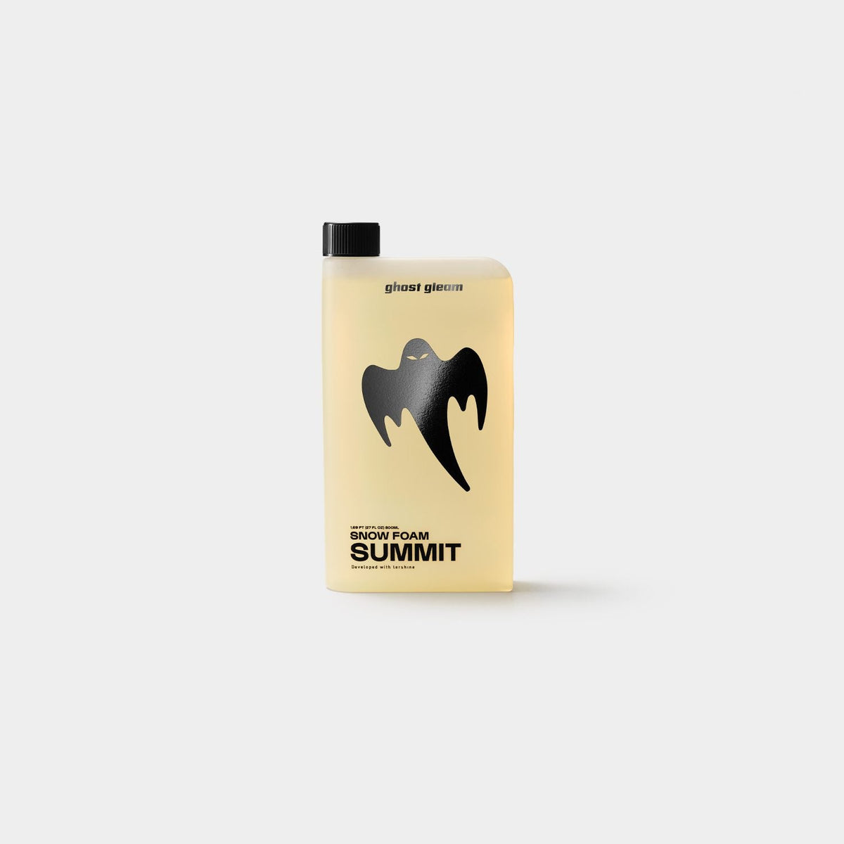 A translucent pale yellow bottle of Summit Snow Foam with a black cap and a black ghost logo on the front, set against a solid light gray background.