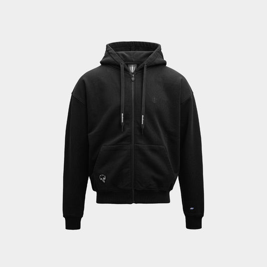 A black zip-up hoodie with a drawstring hood, front pockets, and subtle embroidered logo details, displayed on a clean light gray background.