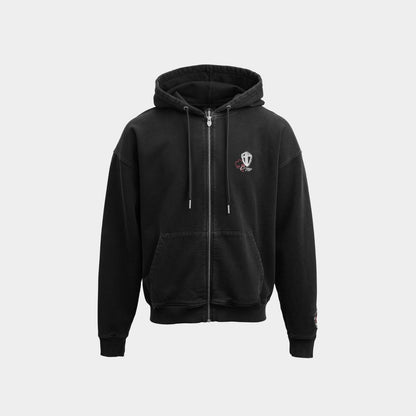 A black zip-up hoodie with a small embroidered crest logo on the left chest, displayed against a solid light gray background.