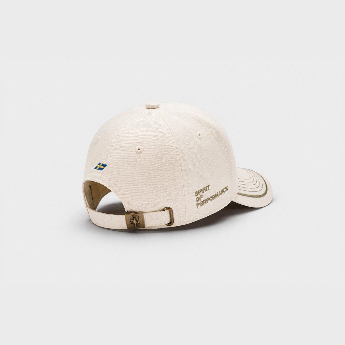 A light beige baseball cap shown from the back, featuring a small Swedish flag patch and the text 'Spirit of Performance' embroidered on the side, set against a plain light gray background.