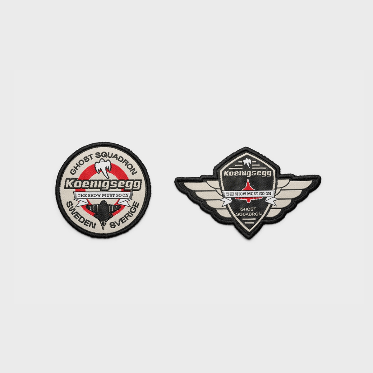 Two embroidered military-style patches on a light gray background: a round patch reading Ghost Squadron Koenigsegg, and a winged shield patch reading Koenigsegg Ghost Squadron