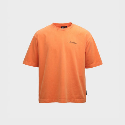 An orange short-sleeve crewneck t-shirt with a small black Sadairs Spear script logo on the left chest, displayed against a light gray background.