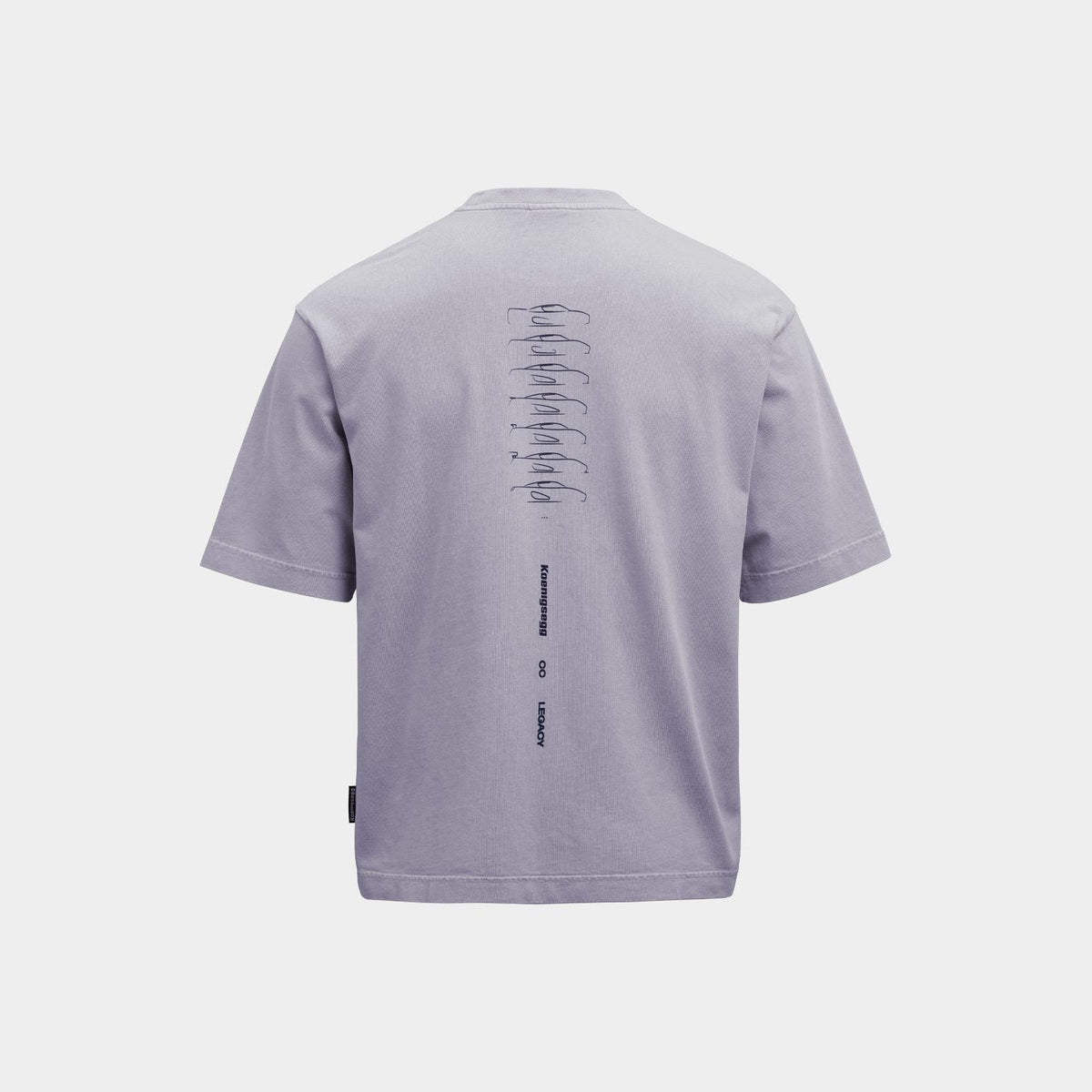 A purple short-sleeve t-shirt shown from the back, featuring a vertical graphic print of stacked cars in black on the upper back and a small black tag near the bottom left hem, set against a solid light gray background.